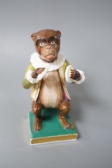 A Derby rare figure from a bear band, c.1820, wearing a green, gold and yellow jacket playing the cymbals, seated on the base, crossed swords mark in blue 10cm